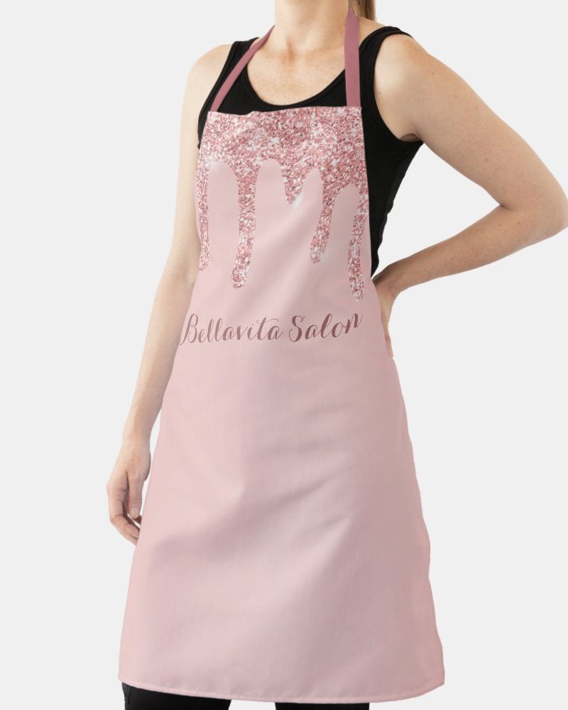 Pink apron with rose gold glitter drips and Bella Vita Salon text.