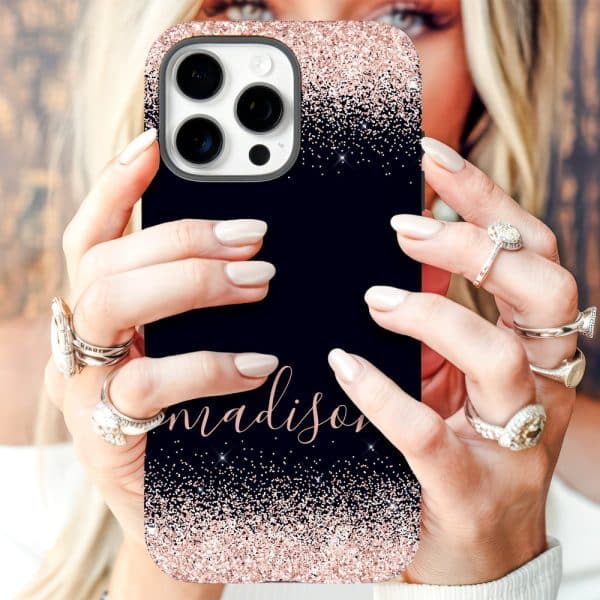 Close-Up Of Hands Holding A Navy Blue Iphone Case With Rose Gold Glitter And The Name Madison.