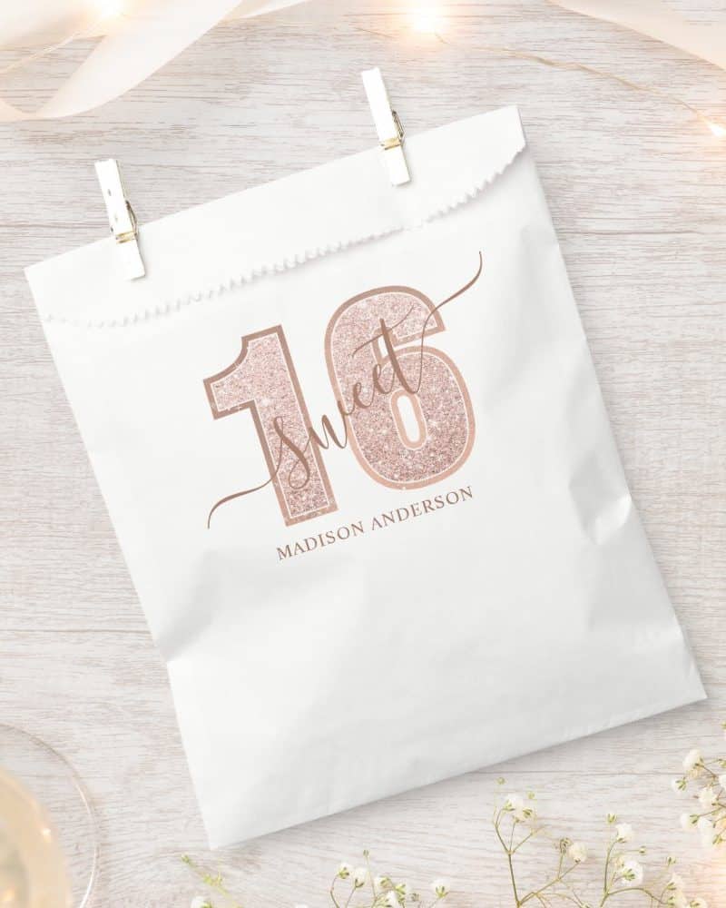 White gift bag with rose gold glitter Sixteen and Sweet 16 design, personalized with a name.