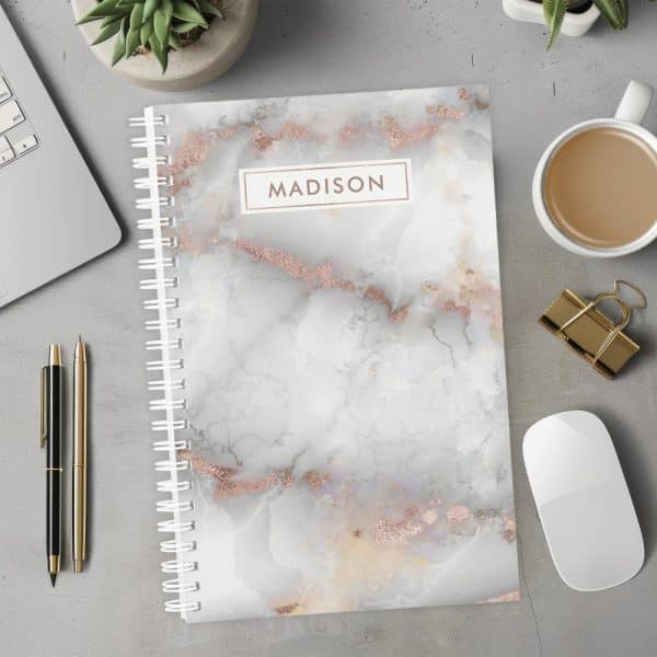 Spiral Notebook With A Rose Gold Marble Design And The Name Madison On The Cover.