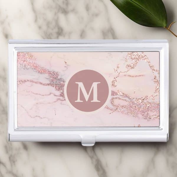 Silver Business Card Holder With A Pink Marble Design And A Central Letter M.