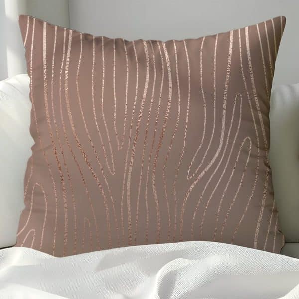 Rose Gold Patterned Throw Pillow On A White Bed.