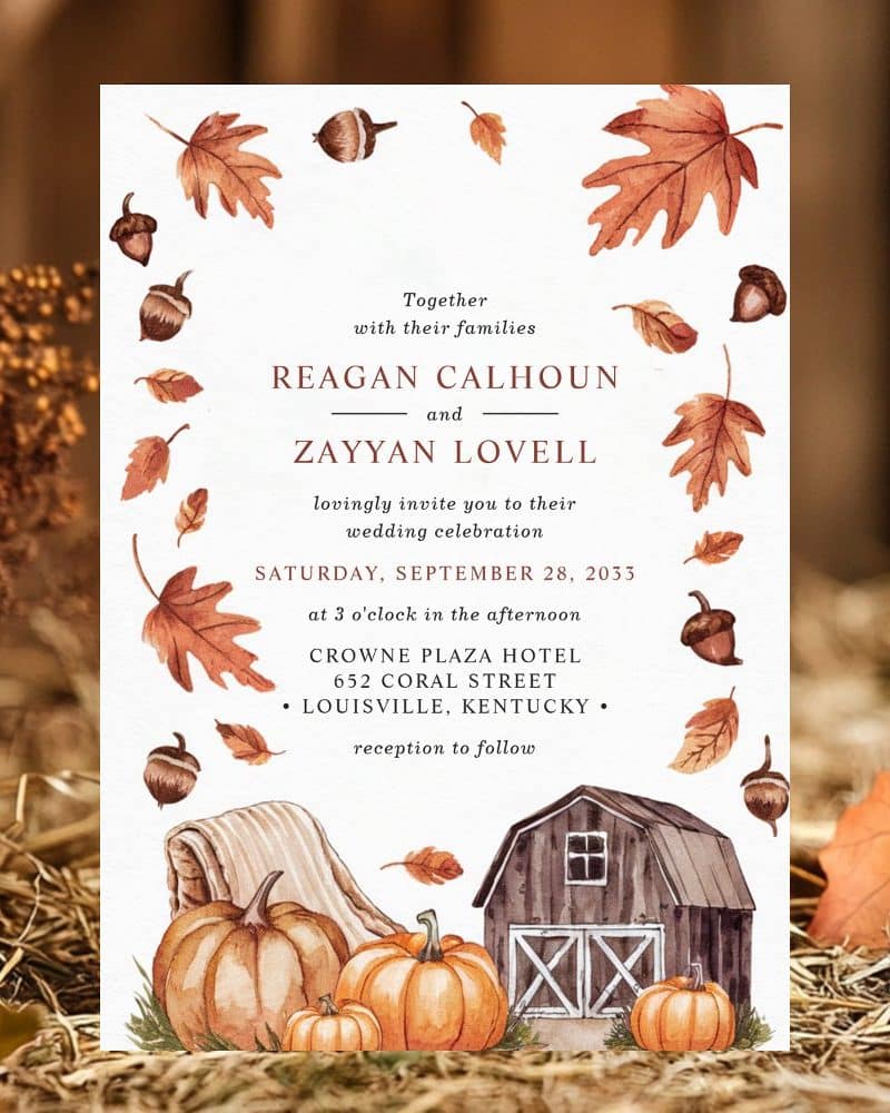 Fall-themed wedding invitation featuring pumpkins, a barn, and autumn leaves.