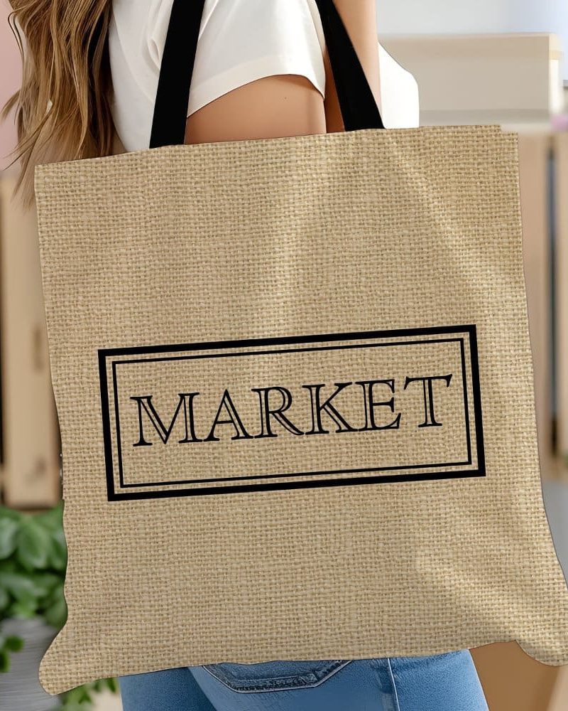 Beige tote bag with black handles and the word MARKET in a black rectangle.