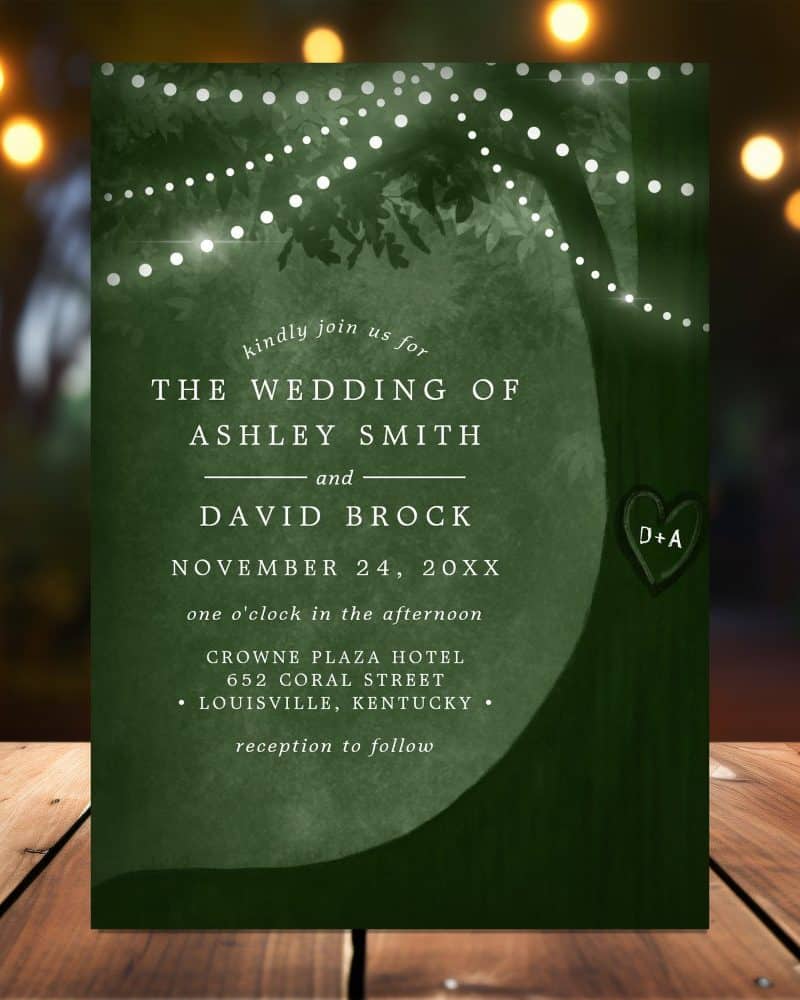 Dark green wedding invitation with tree silhouette, string lights, and wedding details for Ashley Smith and David Brock.