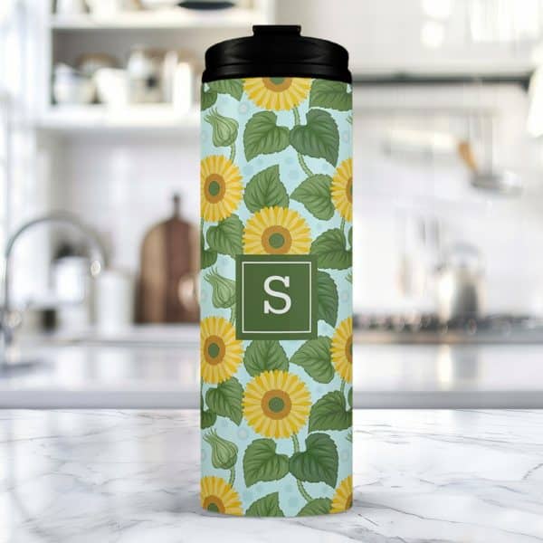 A Travel Mug With A Sunflower And Initial S Design.
