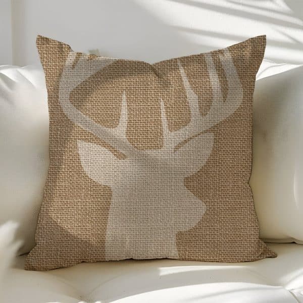 Beige Throw Pillow With A White Deer Silhouette.