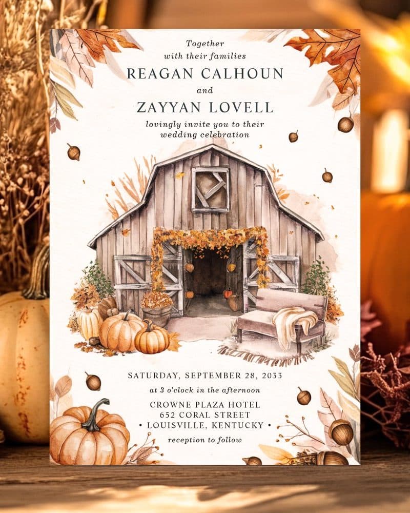 Fall-themed wedding invitation featuring a watercolor painting of a rustic barn with pumpkins and autumn leaves.