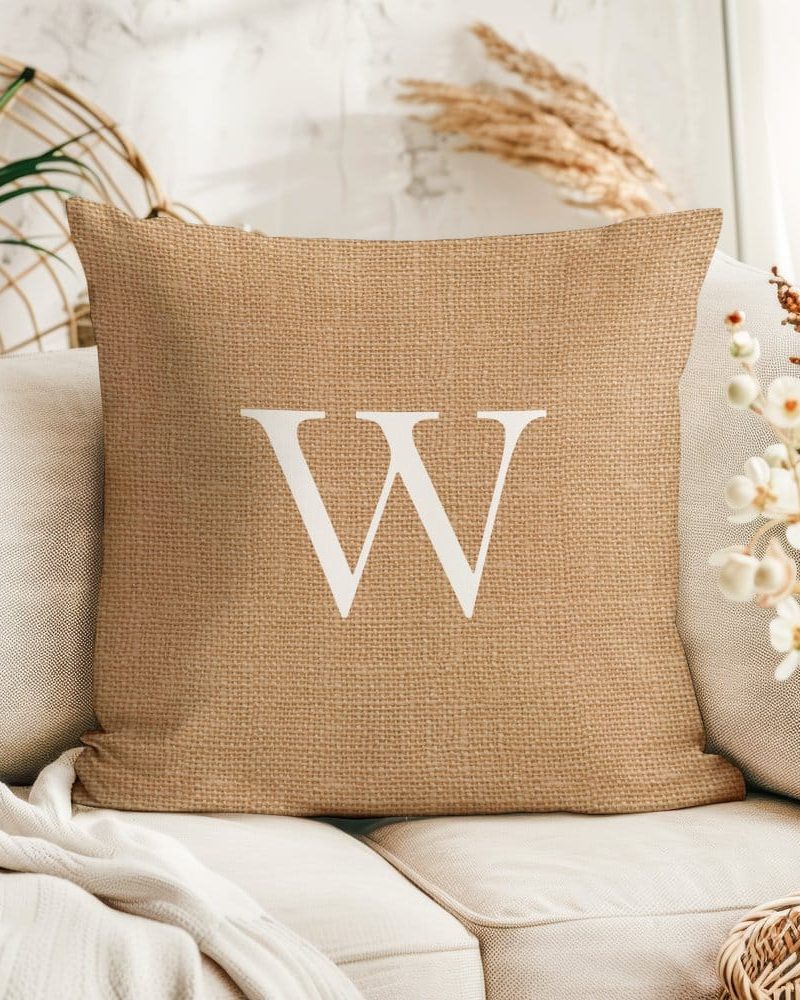 Beige burlap pillow with a large white letter W.