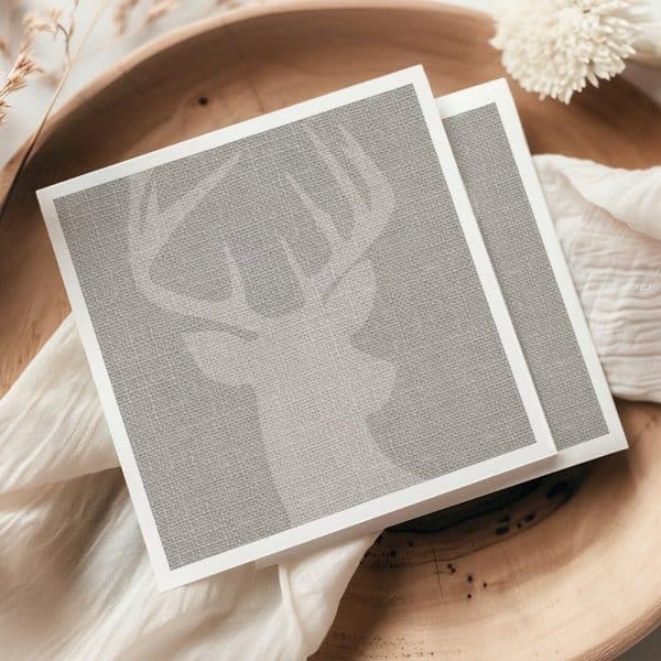 A Taupe Linen Textured Card Features A Subtle, Embossed Image Of A Deer'S Head And Antlers.