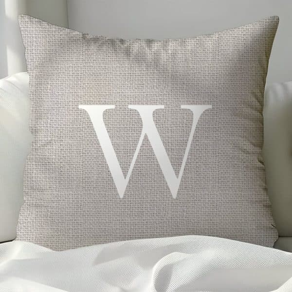Beige Pillow With A Large White Letter W.