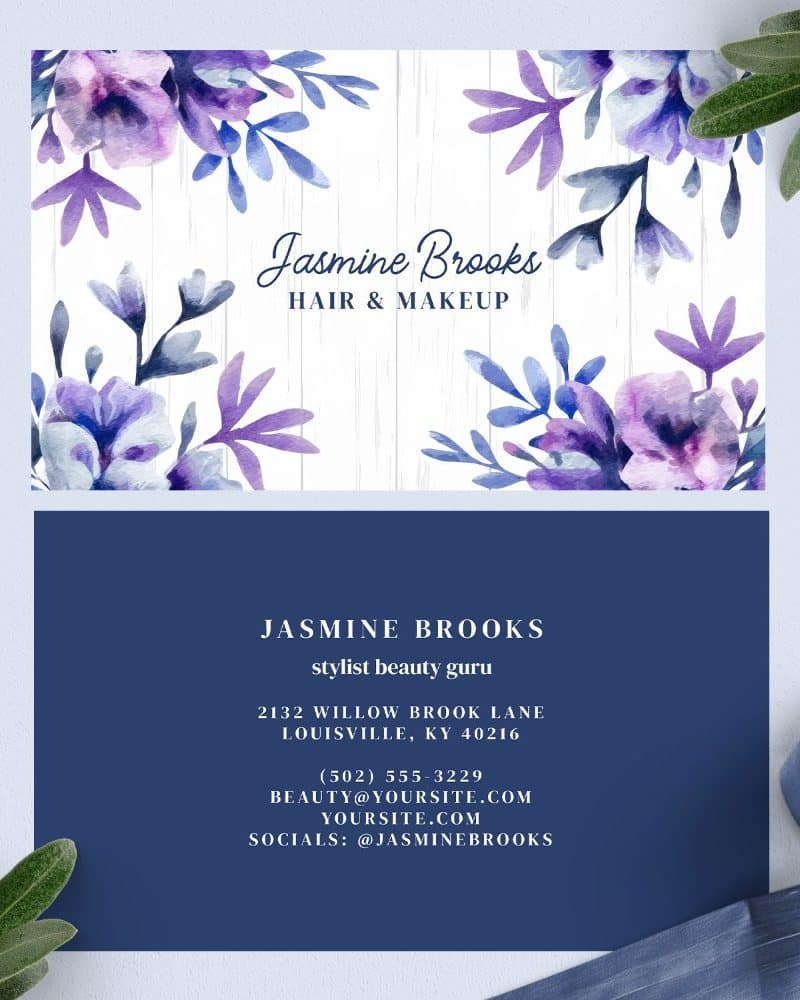 Business card for Jasmine Brooks, hair and makeup stylist, featuring watercolor purple flowers.