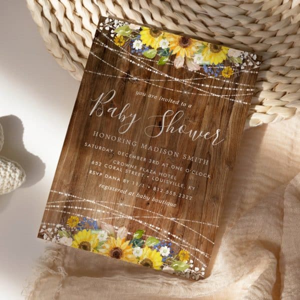Baby Shower Invitation With Sunflowers And String Lights On A Wood Background.