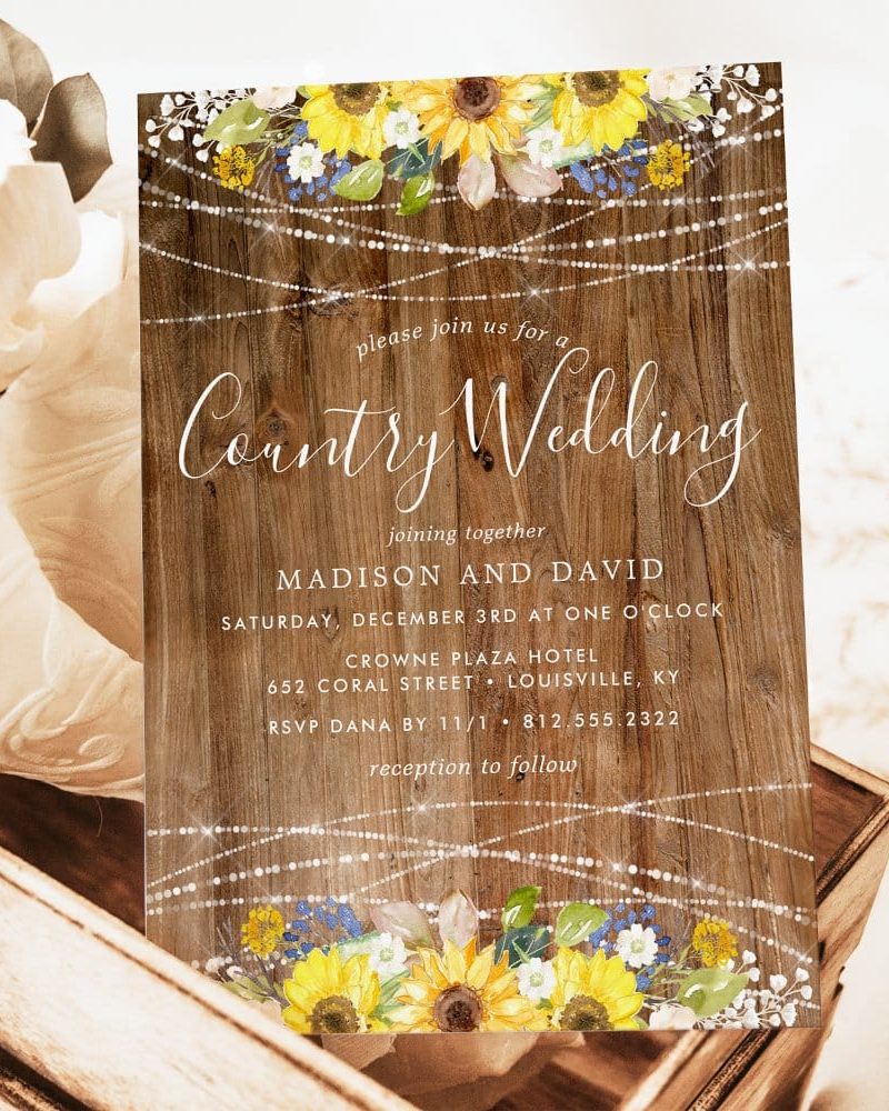 Rustic wedding invitation with sunflowers and string lights.