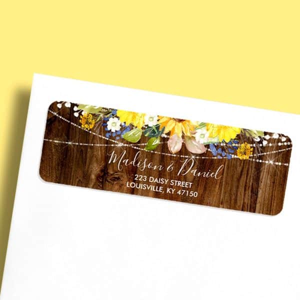 Return Address Label With Sunflowers And String Lights On A Wood Background, Showing Madison &Amp; Daniel'S Address.