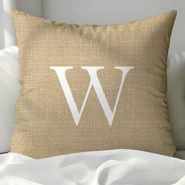 Beige Burlap Pillow With A Large White Letter W.