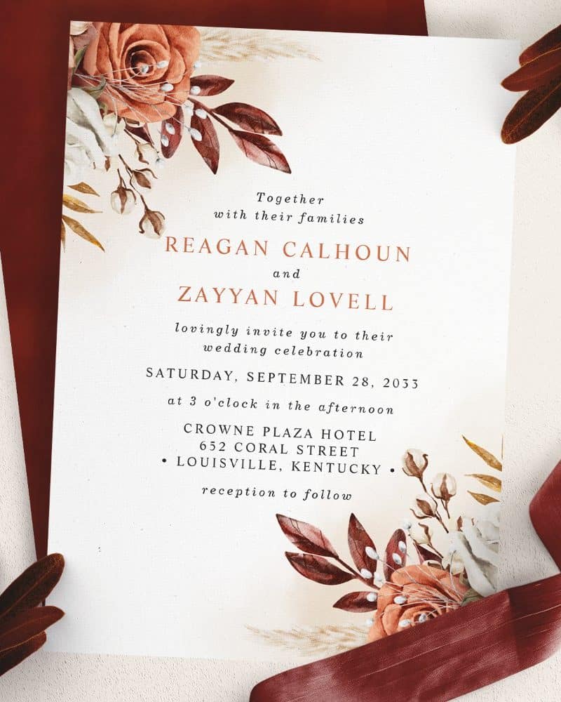 Wedding invitation for Reagan Calhoun and Zayyan Lovell, featuring fall-colored floral designs.