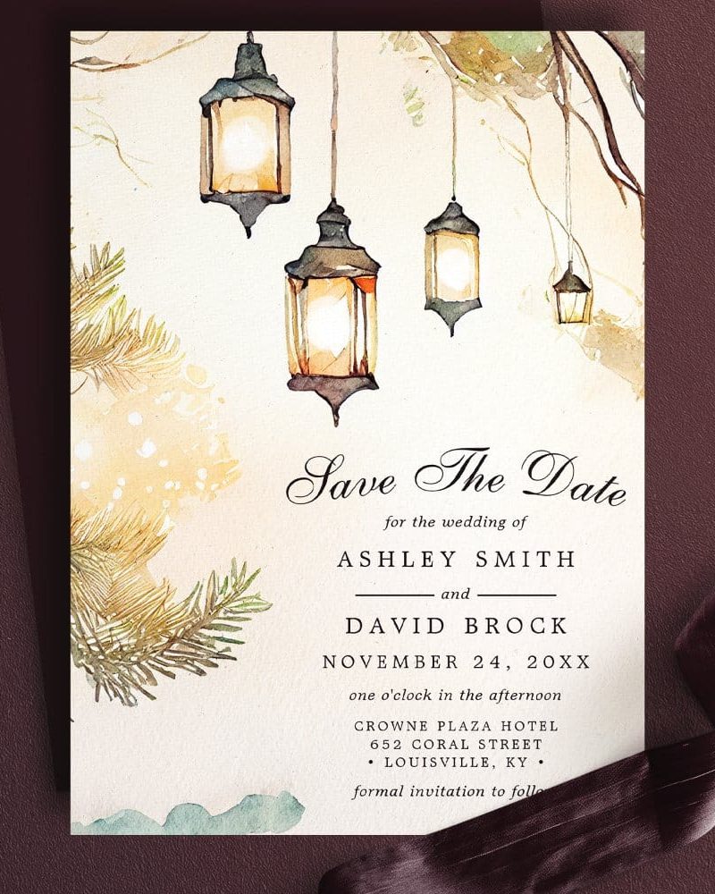 Save the date wedding invitation featuring watercolor lanterns hanging from a tree branch.