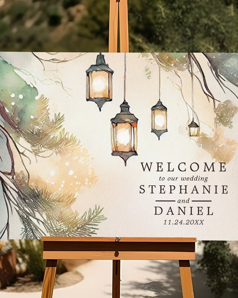 Wedding welcome sign with watercolor painting of lanterns hanging from tree branches. The names Stephanie and Daniel and wedding date are displayed below.