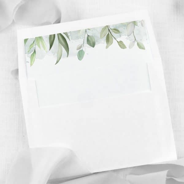 White Envelope With A Light Green Watercolor Leaf Design At The Top.