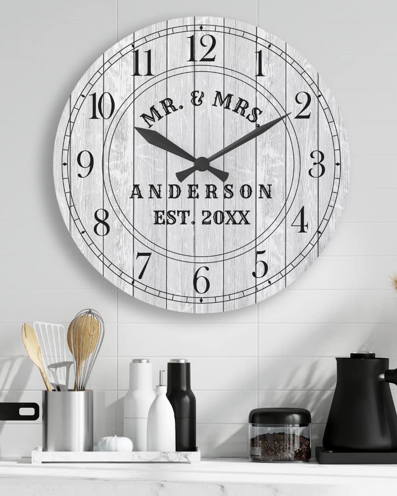 A large white round clock with black hands and personalized text.