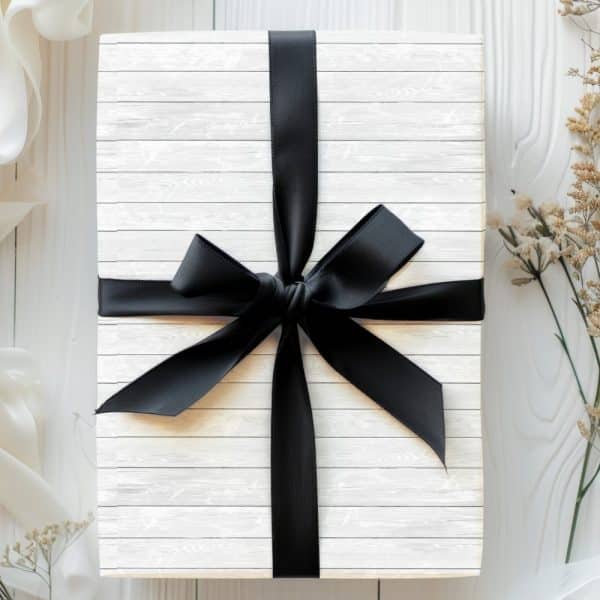 White Gift Box With A Large Black Ribbon Bow.