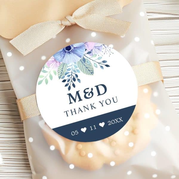 Round Wedding Favor Tag With Blue And Purple Watercolor Flowers, The Initials M&Amp;D, Thank You, And A Date.