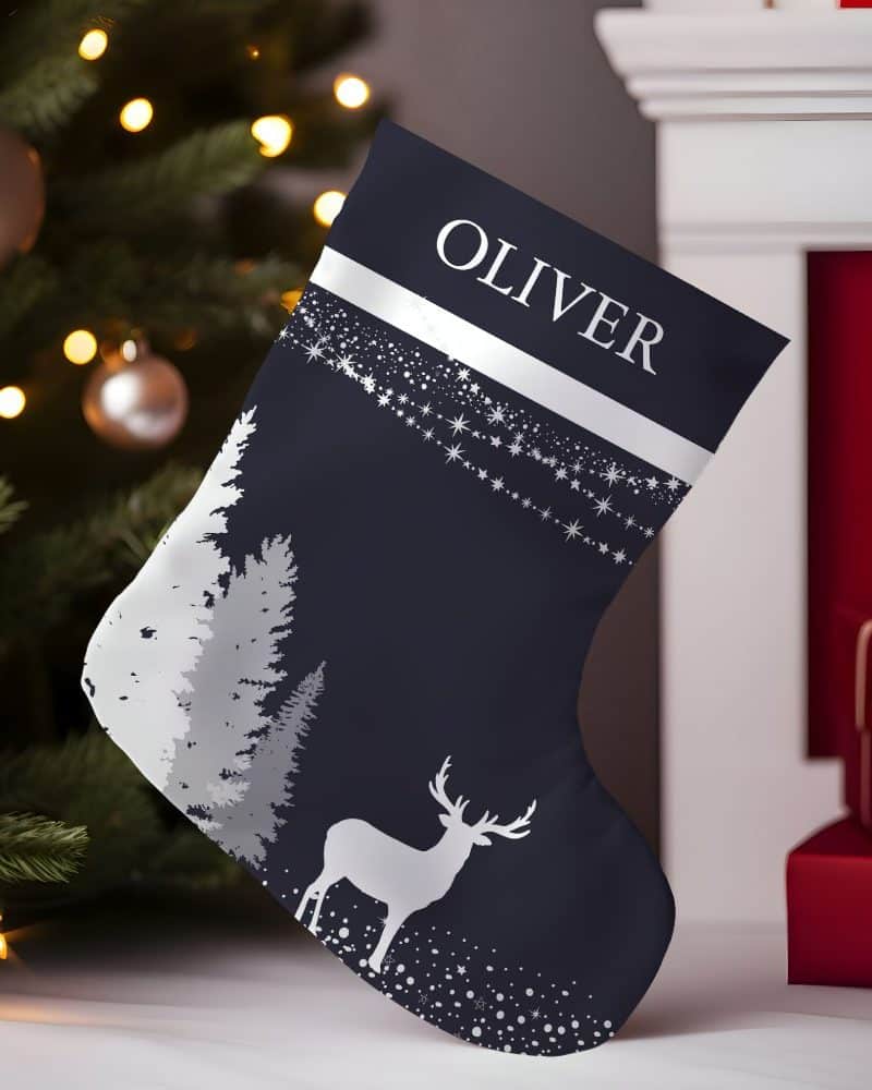 Navy blue Christmas stocking with silver reindeer, trees, and stars, personalized with the name Oliver.