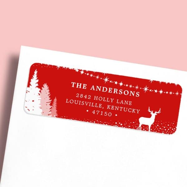 Red Christmas Return Address Label With White Trees, Deer, And The Andersons Family Name And Address.