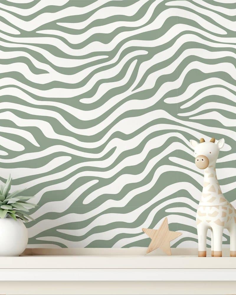 Sage green and white zebra striped wall with a small giraffe toy and potted plant on a shelf.