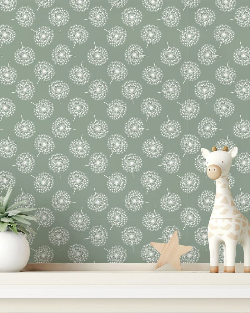 Sage green wall with a repeating dandelion pattern, featuring a small giraffe toy and a potted plant on a shelf.