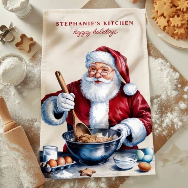 A Kitchen Tea Towel Featuring Santa Claus Baking.