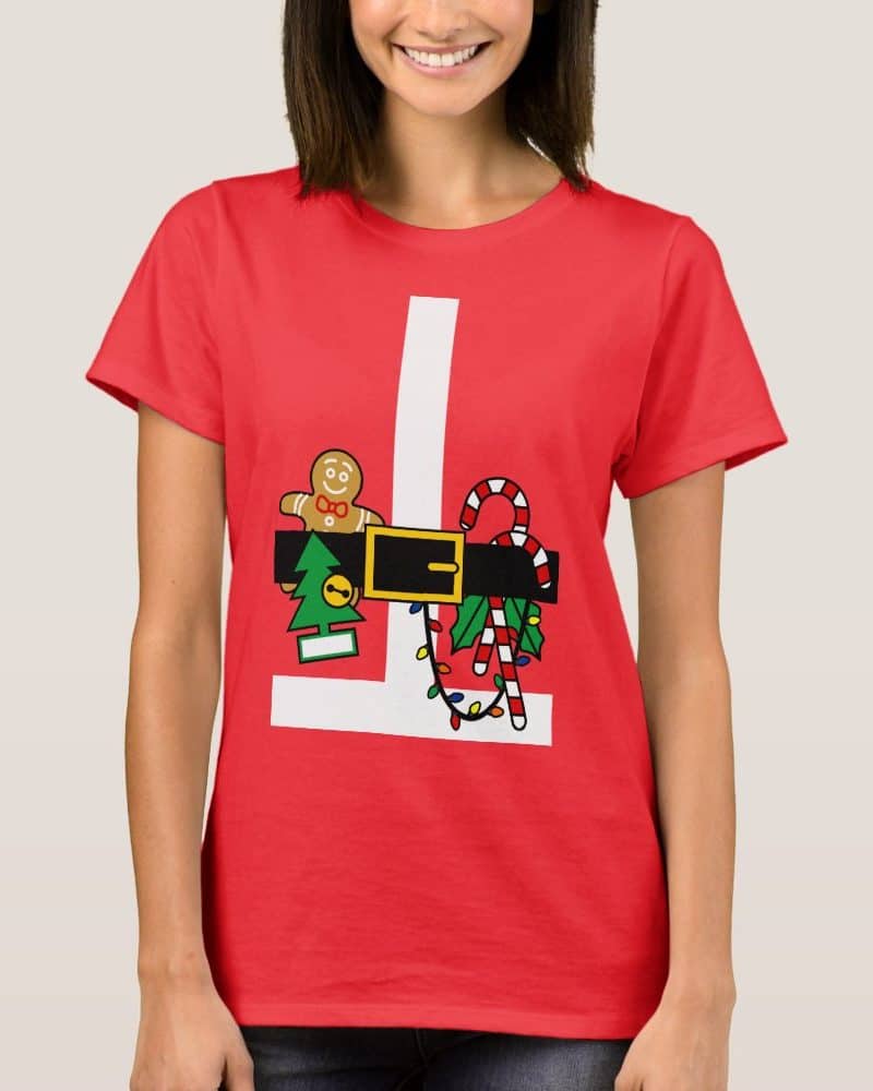 Woman wearing a red t-shirt with a graphic of Santas belt and various Christmas treats.