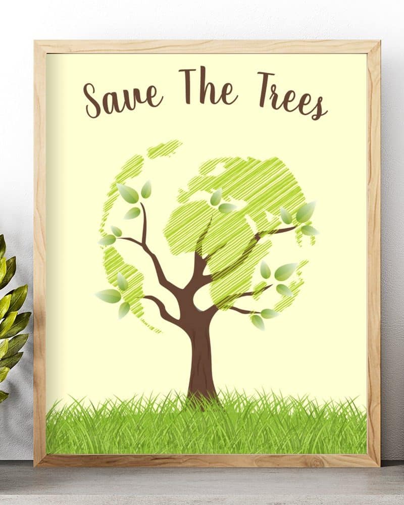 Framed poster with the text Save The Trees above an illustration of a tree whose leaves form a world map, set in grass.