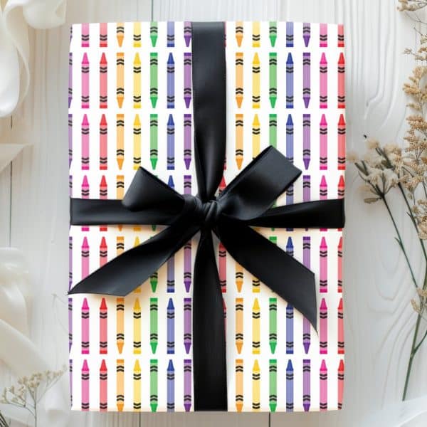 Gift Wrapped With Crayon Patterned Paper And A Black Ribbon.