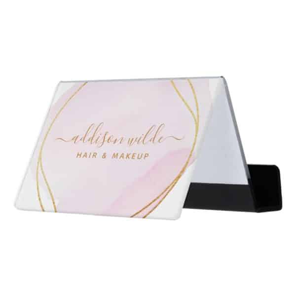 A Pink And Gold Business Card Holder Displaying Addison Wilde Hair &Amp; Makeup.