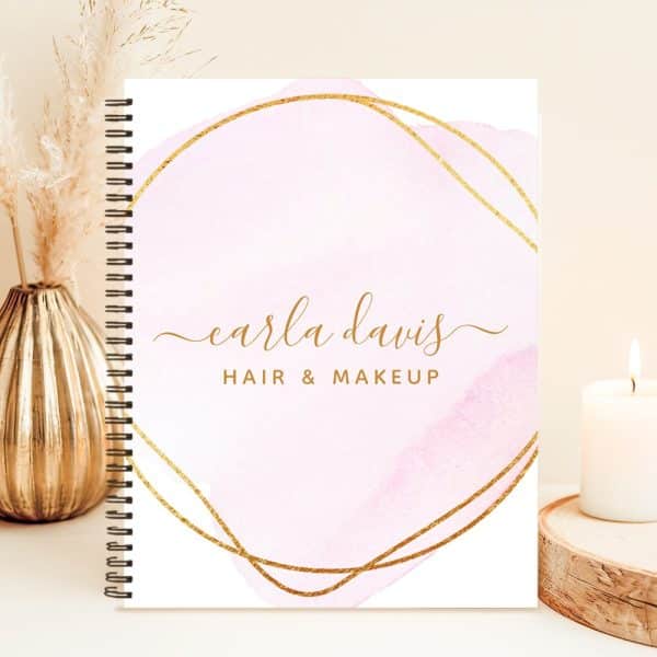 Spiral-Bound Notebook With A Pink Watercolor Design And Gold Lettering; Carla Davis Hair &Amp; Makeup.