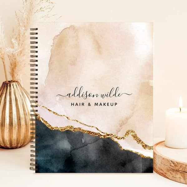 Spiral-Bound Notebook With An Abstract Watercolor Design In Shades Of Beige, Black, And Gold, And The Name Addison Wilde Hair &Amp; Makeup.