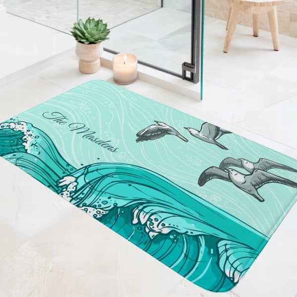 Teal Bath Mat With An Ocean Wave Design, Seagulls, And The Name Masters.