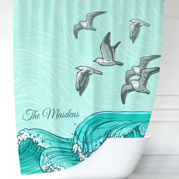 Shower Curtain Depicting Teal Waves And Several Seagulls Flying Above. The Name &Quot;The Masdens&Quot; Is Printed On The Curtain.