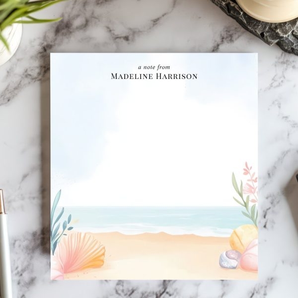 Personalized Stationery Featuring A Beach Scene With Seashells And Plants.