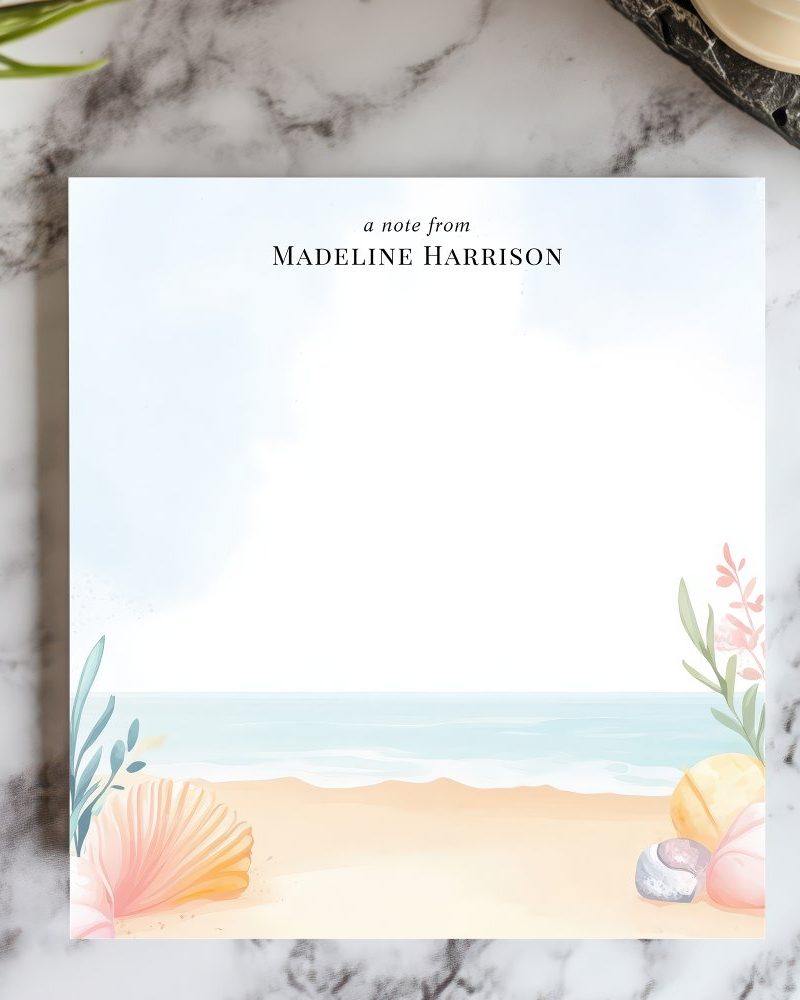 Personalized stationery featuring a beach scene with seashells and plants.