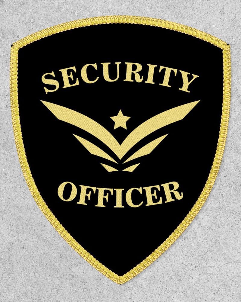 Black shield-shaped security officer patch with gold trim and lettering.