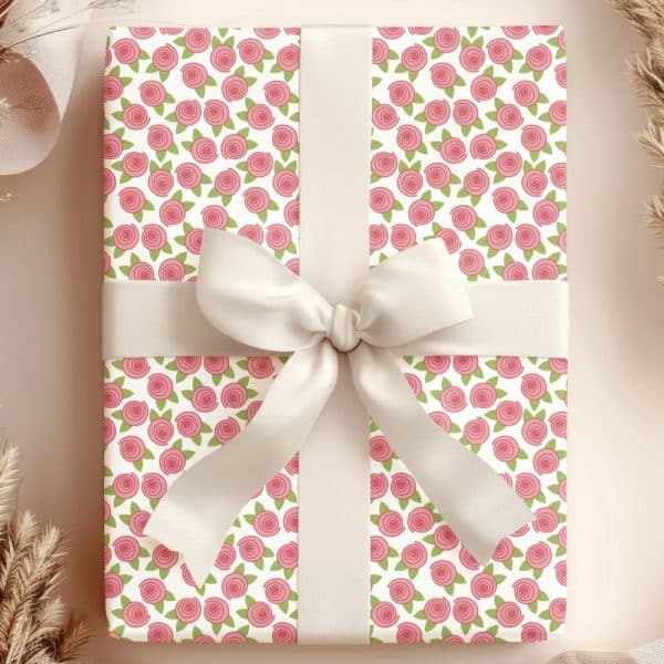 A Gift Wrapped In Pink Rose Patterned Paper With A Cream-Colored Ribbon.