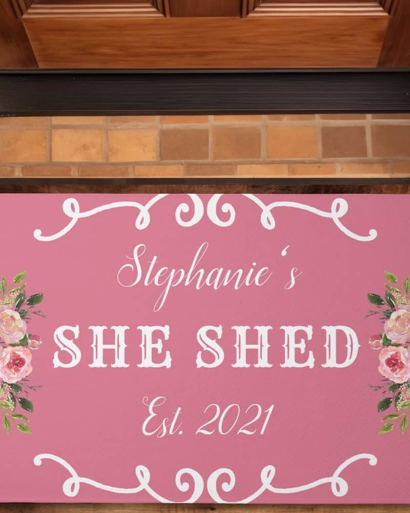 Pink doormat with Stephanie's She Shed Est. 2021 and floral designs.