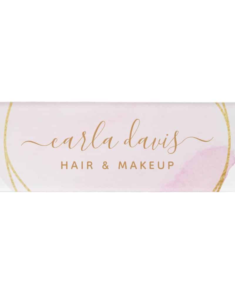 Carla Davis Hair & Makeup logo with gold circular design element on a pink watercolor background.