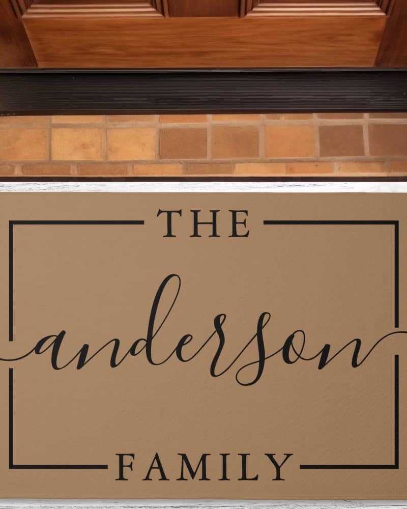 Tan doormat with The Anderson Family in a black sans serif and script font.