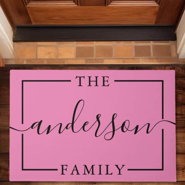 Pink Doormat With The Text The Anderson Family In A Black Sans-Serif Font.