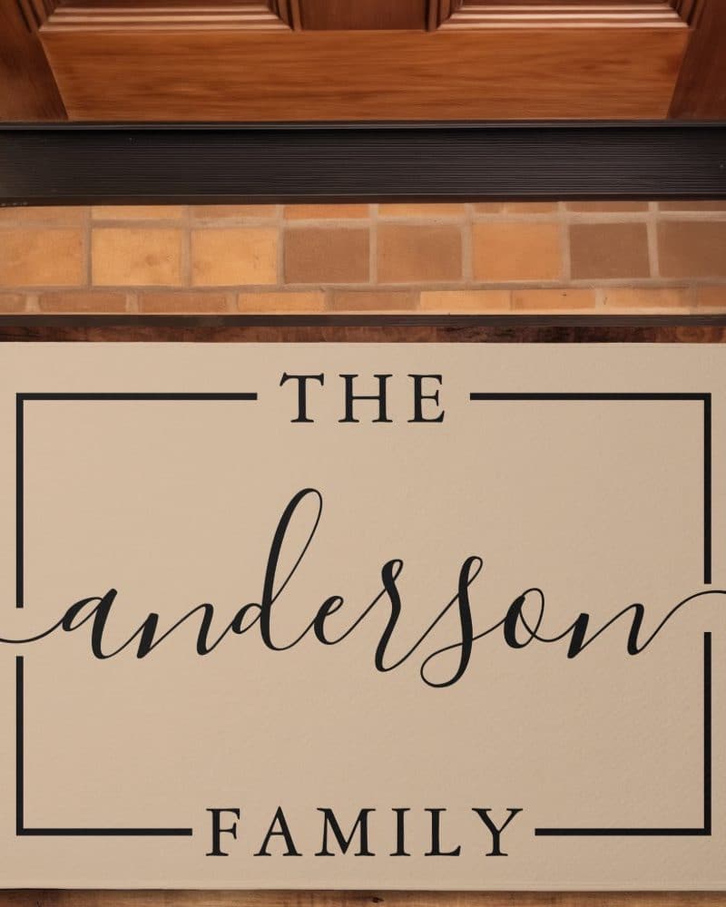 Beige doormat with the text The Anderson Family in a simple, elegant font.