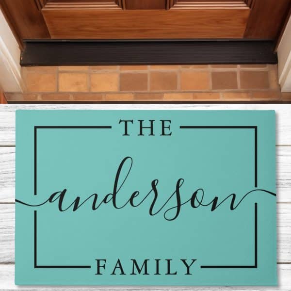 Teal Welcome Mat With The Text The Anderson Family In A Black Sans-Serif Font.